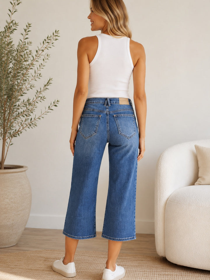 Audrina Cropped Wide Leg Jean – Mid Blue — full body back facing styled image | Bianco Jeans