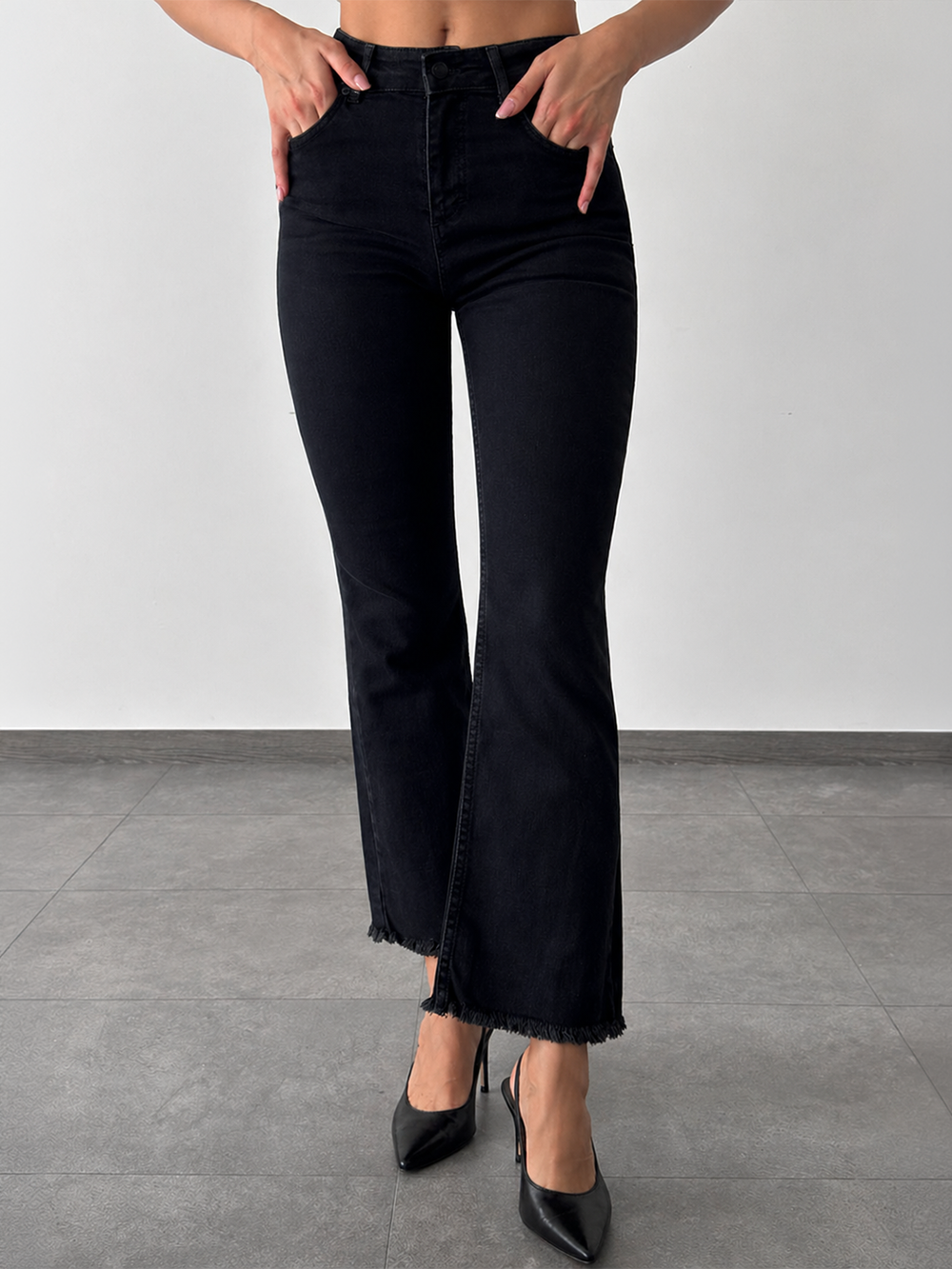 Mila Mini Flare Jean in Black – half body front view styled