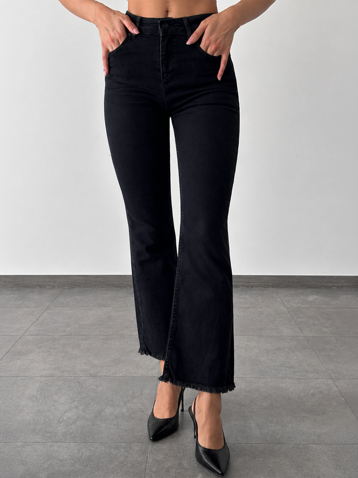 Mila Mini Flare Jean in Black – half body front view styled