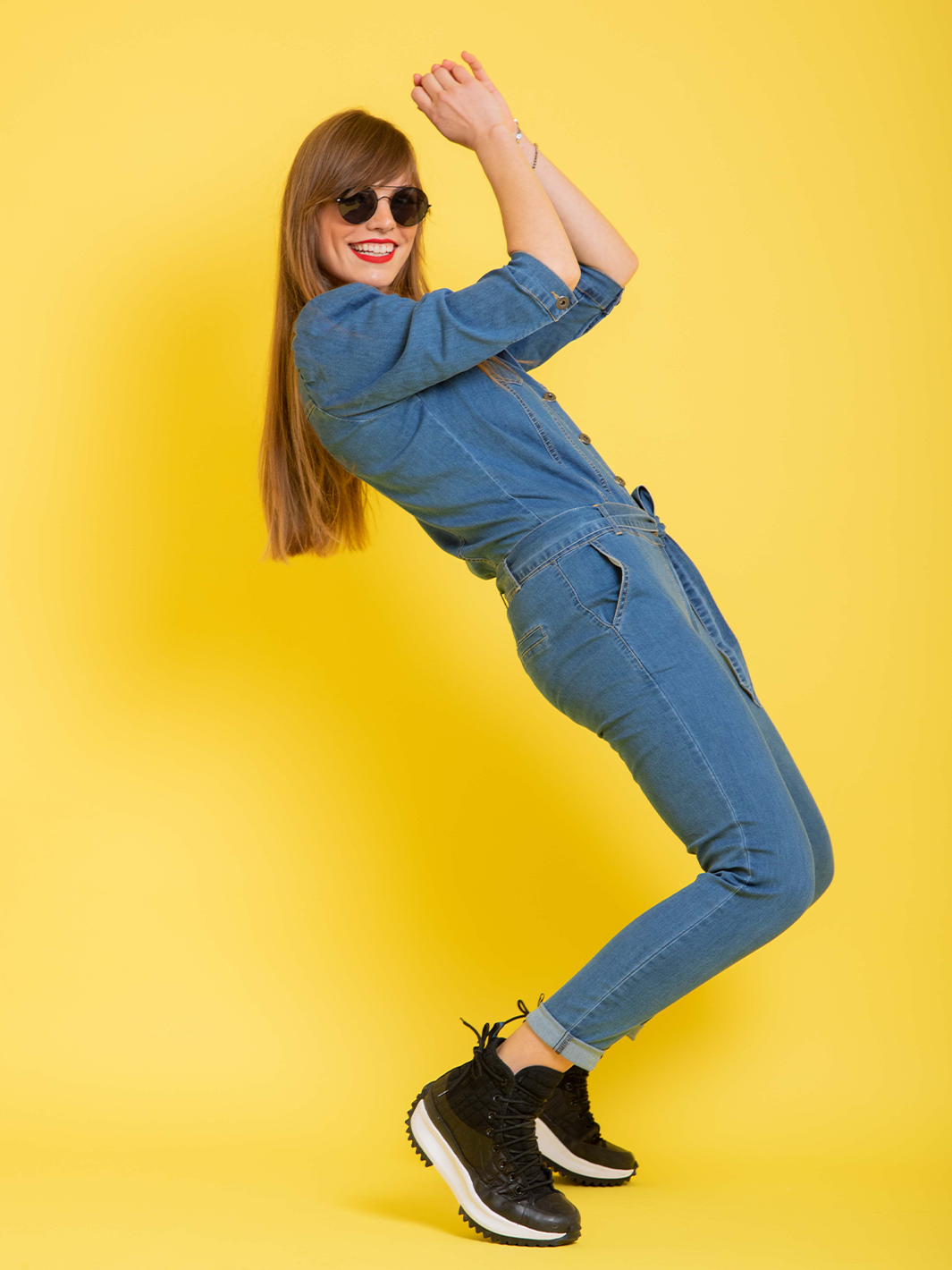 Nina Denim Jumpsuit — full body side view in motion, stretch denim with self-tie waist belt | Bianco Jeans